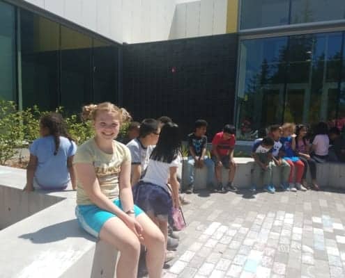 Kids in courtyard before the start of the Peace Pole Planting Ceremony out at Rockwood Boys & Girls Club