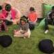 Five children sit, listen to music, and meditate in the Regence Club Peace Room